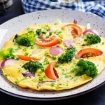 omelette-with-broccoli-tomatoes-red-onions-dark-table-italian-frittata-with-vegetables_2829-20241